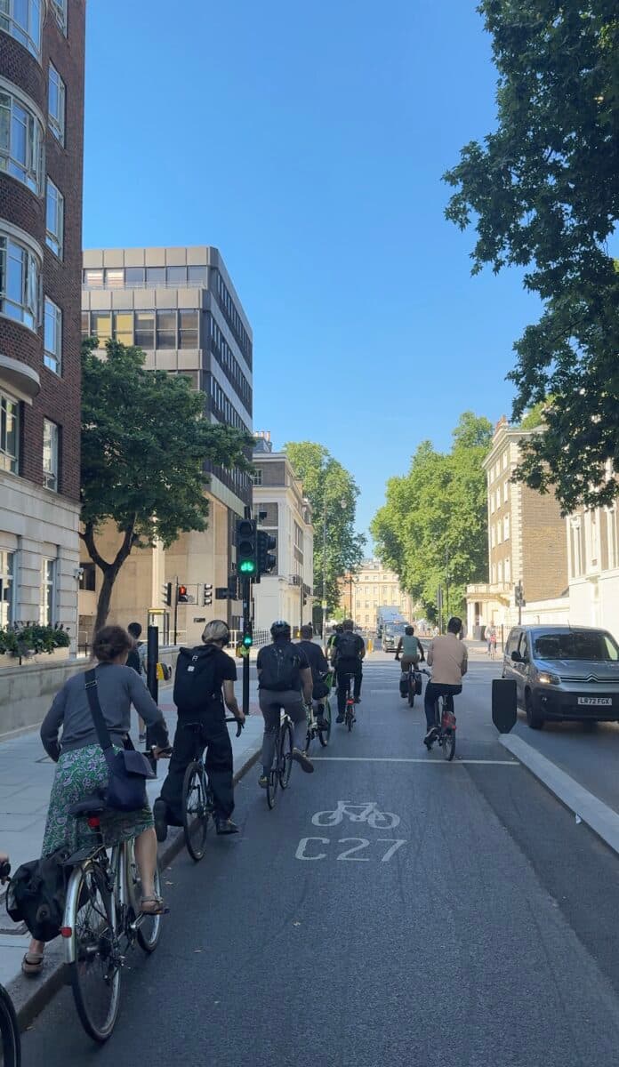 A group of riders on the C27 cycleway through central London on a sunny morning
